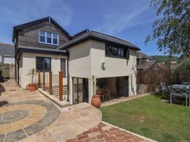 A house exterior with garden and outdoor dining table at Mayflower Cottage Lyme Regis