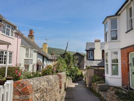 A street lined with houses and flowers at Mayflower Cottage in Lyme Regis