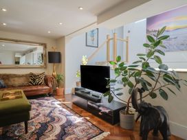 A living room with a sofa and coffee table at Mayflower Cottage in Lyme Regis