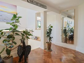 A hallway with plants and a mirror at Mayflower Cottage in Lyme Regis