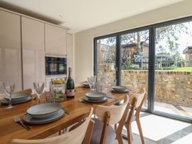 A dining room with a table set for a meal at Mayflower Cottage in Lyme Regis