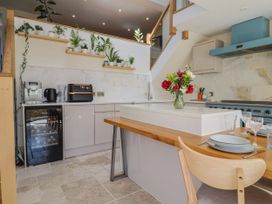 A kitchen with a cooking area and dining space at Mayflower Cottage in Lyme Regis