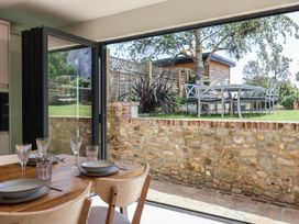A dining area with a view of the garden at Mayflower Cottage in Lyme Regis