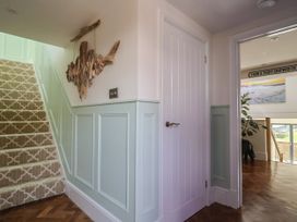 A hallway with stairs and a door at Mayflower Cottage in Lyme Regis