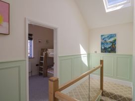 A landing with a staircase and a bunk bed at Mayflower Cottage in Lyme Regis