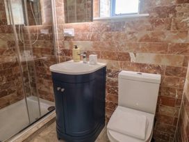 A bathroom with a shower, toilet, and sink at Mayflower Cottage in Lyme Regis