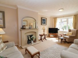 A living room with a fireplace and television at Number 10, Broadway
