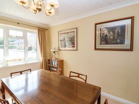 A dining room with a table, chairs, and wall art at Number 10, Broadway