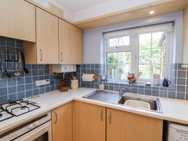 A kitchen with cabinets, sink, and window at Number 10, Broadway