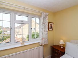 A bedroom with a window and wooden nightstand at Number 10, Broadway