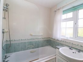A bathroom with a bathtub and sink at Number 10, Broadway
