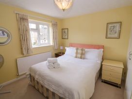 A bedroom with a bed and window at Number 10, Broadway