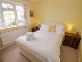 A bedroom with a double bed and bedside table at Number 10, Broadway