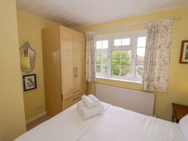 A bedroom with a bed and wardrobe at Number 10, Broadway