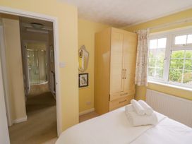 A bedroom with a bed and wardrobe at Number 10, Broadway