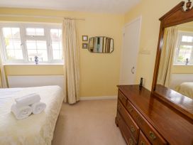 A bedroom with a bed and dresser at Number 10, Broadway