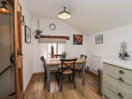 A dining room with a table and chairs at Over Brow Cottage, Coniston