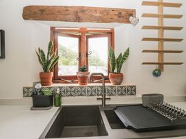 A kitchen with a sink and window at Over Brow Cottage in Coniston