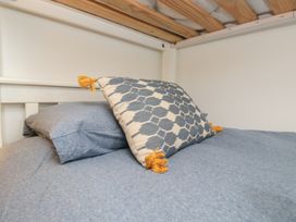 A bed with pillows at Over Brow Cottage in Coniston