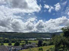 A view of houses and fields overlooking a lake at Over Brow Cottage in Coniston