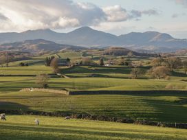 A landscape with fields and sheep in the foreground at Over Brow Cottage in Coniston