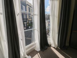 A window with curtains and a street view at Sea Suite in 