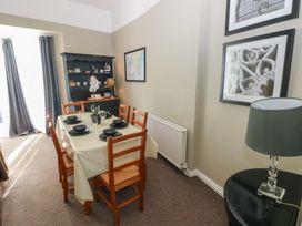 A dining room with a table and chairs at Sea Suite
