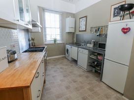 A kitchen with appliances and cabinets at Sea Suite