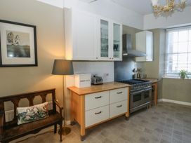 A kitchen with cabinets and appliances at Sea Suite 