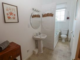 A bathroom with a sink and a shower at Sea Suite 