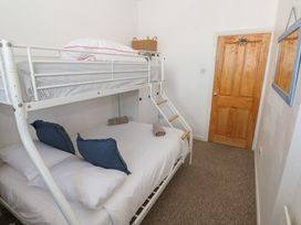 A bedroom with a bunk bed and a double bed at Sea Suite
