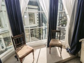 A sitting room with two chairs and a window at Sea Suite in 