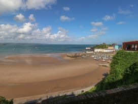 A beach view with boats and buildings at Sea Suite 