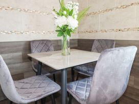 A dining room with a table and chairs at Two Bed Apartment No.4 Newquay