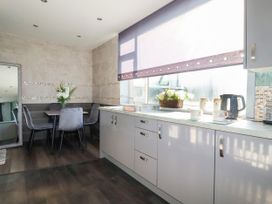 A kitchen with a table and chairs at Two Bed Apartment No.4 Newquay