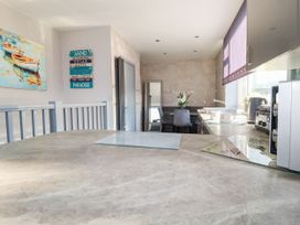 A kitchen with a table and chairs at Two Bed Apartment No.4 Newquay