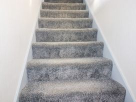 A staircase with carpet steps at Two Bed Apartment No.4 Newquay