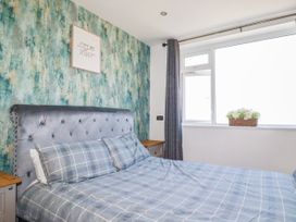 A bedroom with a bed and window at Two Bed Apartment No.4 Newquay