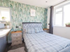 A bedroom with a bed and nightstand at Two Bed Apartment No.4 in Newquay