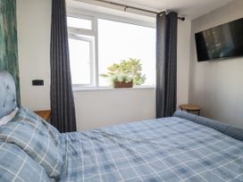 A bedroom with a bed and a window at Two Bed Apartment No.4 Newquay