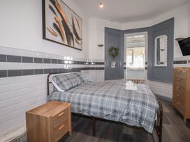 A bedroom with a bed and nightstand at Penthouse No.3 in Newquay