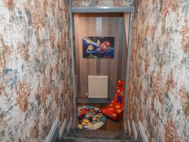 A hallway with a staircase and wall art at Penthouse No.3 in Newquay