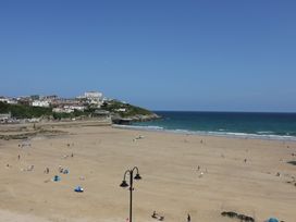 A beach with people and buildings at Penthouse No.3 in Newquay