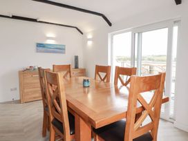 A dining room with a table and chairs at Little House in Wadebridge