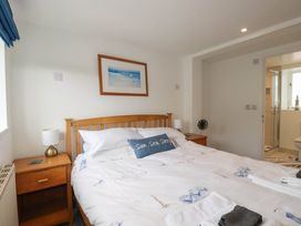A bedroom with a bed and nightstands at Little House in Wadebridge