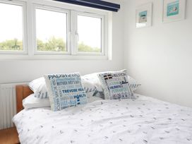 A bedroom with a bed and pillows at Little House in Wadebridge