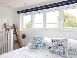 A bedroom with a bed and window at Little House in Wadebridge