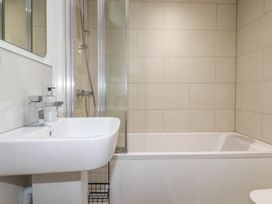 A bathroom with a bathtub, shower, and sink at Little House in Wadebridge