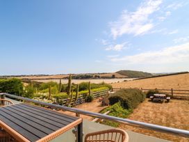 A view from a balcony overlooking fields and hills at Little House in Wadebridge