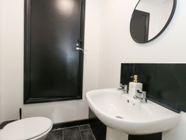A bathroom with a toilet and wash basin at Ocean Breeze in Weymouth